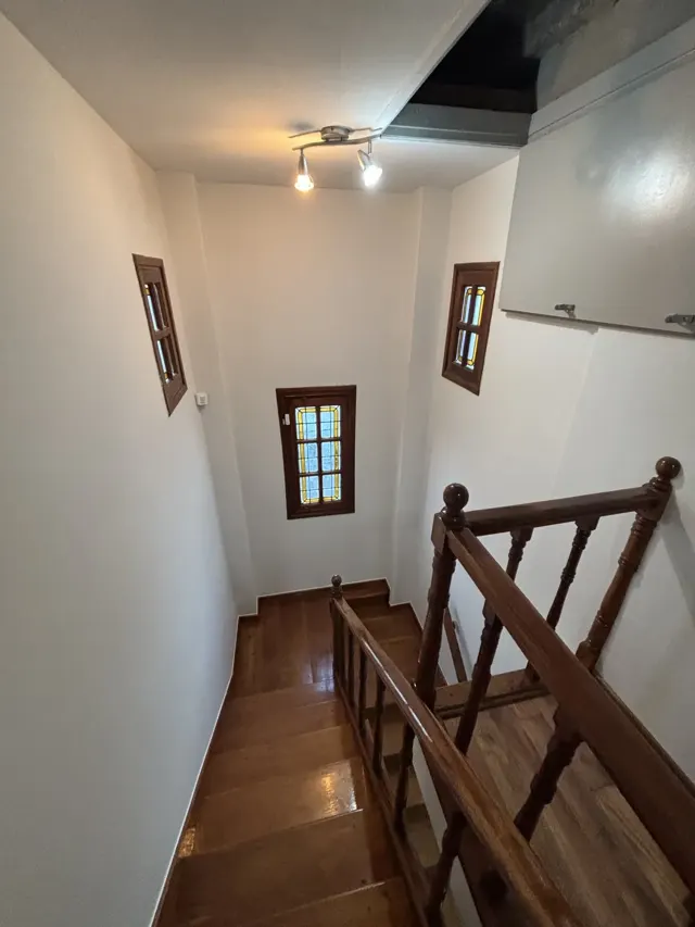 Escalera y pasillo de casa con paredes blancas recién pintadas